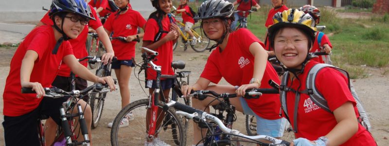 Students with bikes and helmets in a Chinese village